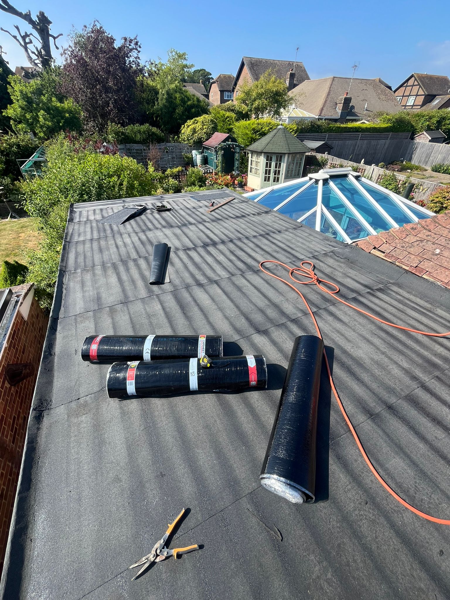 Flat roof with new roofing material applied