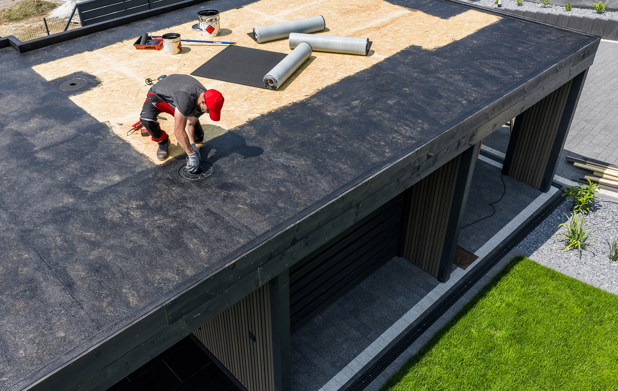 Roofer Applying EPDM Roofing Material